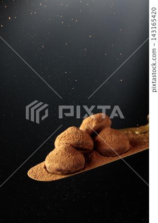 Chocolate truffles on a vintage brass cake server. Chocolate truffles on a vintage brass cake server. 143165420