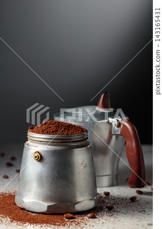 Coffee preparation in a classic Italian aluminium moka pot. Coffee preparation in a classic Italian aluminium moka pot. 143165431