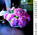 Hydrangea flower arrangement, large pink and purple hydrangea flowers arranged in a glass vase. 143165607