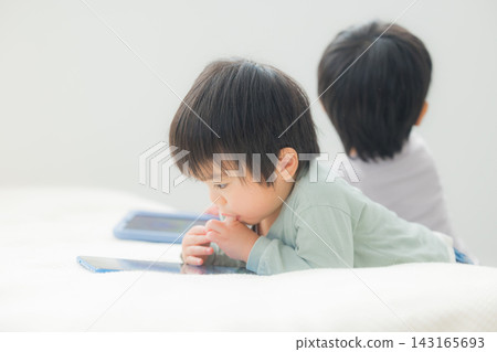 Children watching tablets Children watching tablets 143165693