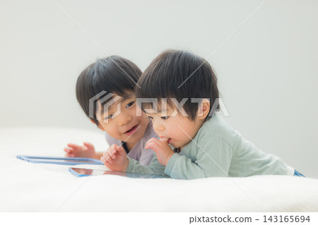 Children watching tablets Children watching tablets 143165694