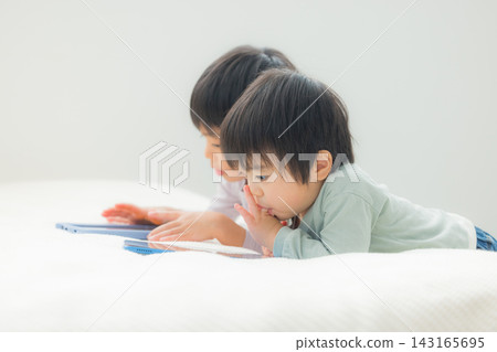 Children watching tablets Children watching tablets 143165695