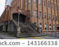The brown exterior walls and grand staircase of Hibiya Public Hall, a historic building located in Hibiya Park. 143166338