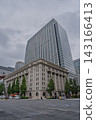 The Meiji Life Insurance Building and the Meiji Yasuda Life Insurance Building stand tall along Hibiya Street. 143166413