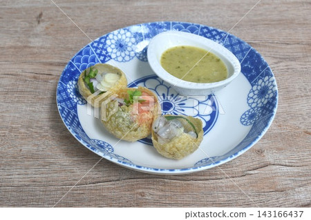 panipuri Indian snack fried crispy flour ball stuffed raw salmon and shrimp with vegetable dipping Thai spicy seafood sauce on plate panipuri Indian snack fried crispy flour ball stuffed raw salmon and shrimp with vegetable dipping Thai spicy seafood sauce on plate 143166437