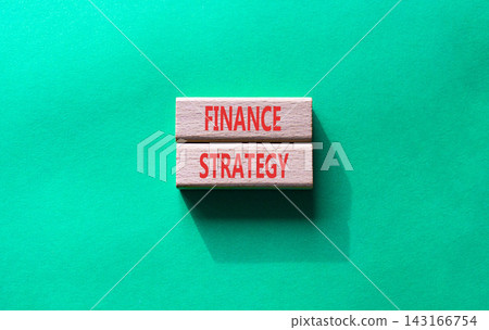 Finance strategy symbol. Concept word Finance strategy on wooden blocks. Beautiful green background. Business and Finance strategy concept. Copy space Finance strategy symbol. Concept word Finance strategy on wooden blocks. Beautiful green background. Business and Finance strategy concept. Copy space 143166754