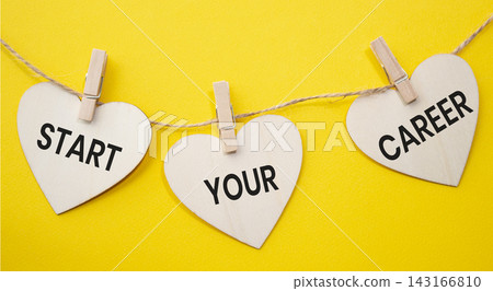 Start Your Career text on wooden heart tags hanging on rope with clothespins over yellow background. Career development and professional growth concept with copy space. Start Your Career text on wooden heart tags hanging on rope with clothespins over yellow background. Career development and professional growth concept with copy space. 143166810