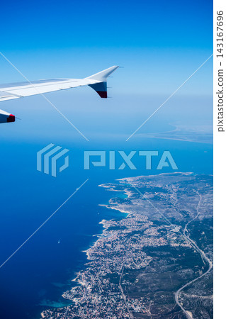 From an airplane, I saw the cityscape of Nice on the French Riviera, the mountains, and the Mediterranean Sea from the air. 143167696