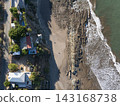 Rocky stone beach with houses above top view 143168738