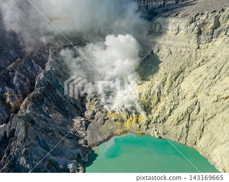 Mist curls gently from the jagged, volcanic rim Mist curls gently from the jagged, volcanic rim 143169665