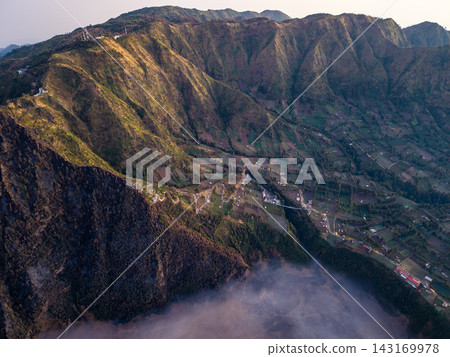Golden light drapes mountain ridgelines 143169978