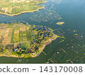 Aerial view of a tranquil lake with farming ponds 143170008