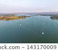 Aerial View of Serene Lake with Boats and Scenic Landscape Surroundings 143170009