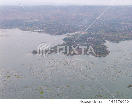 Aerial View of Serene Lake Surrounded by Greenery and Farmland Aerial View of Serene Lake Surrounded by Greenery and Farmland 143170010