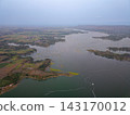 Aerial View of Serene Landscape with Water, Fields, and Mountains 143170012