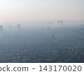 Hazy morning shrouds city skyline in muted tones 143170020