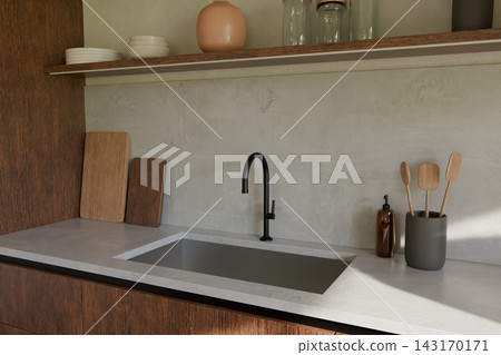 Concrete worktop with black gooseneck faucet and wooden boards Concrete worktop with black gooseneck faucet and wooden boards 143170171