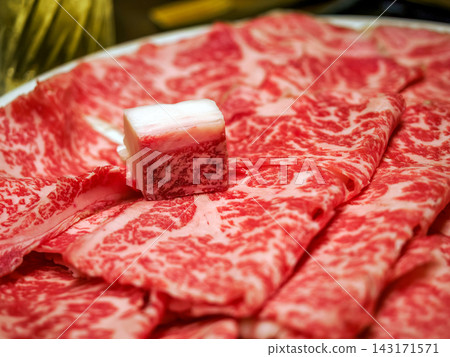 High-grade Japanese Black Wagyu beef (A5 grade, marbled sliced meat) for sukiyaki and shabu-shabu. High-grade Japanese Black Wagyu beef (A5 grade, marbled sliced meat) for sukiyaki and shabu-shabu. 143171571