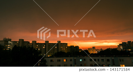 Dramatic Orange Sunset Over Residential City After Thunderstorm Dramatic Orange Sunset Over Residential City After Thunderstorm 143171584