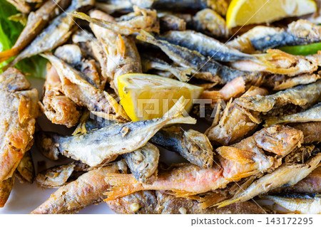 little local fried fishes close-up on plate little local fried fishes close-up on plate 143172295