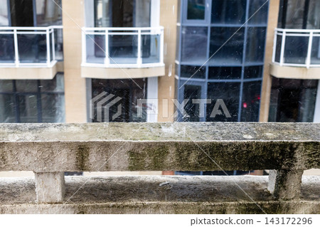 rain drops shatter against stone balcony parapet rain drops shatter against stone balcony parapet 143172296