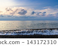 view of sea water surf and low clouds at dusk 143172310