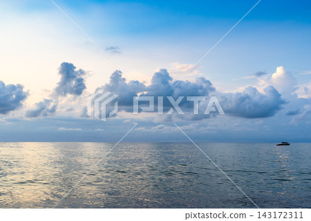 low clouds in dark blue sky over sea water at dusk 143172311
