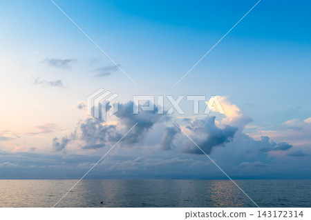 low cumuli cloud in dark blue sky in over calm sea low cumuli cloud in dark blue sky in over calm sea 143172314