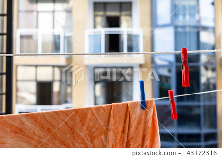 washed clothes drying on rope close-up on balcony washed clothes drying on rope close-up on balcony 143172316