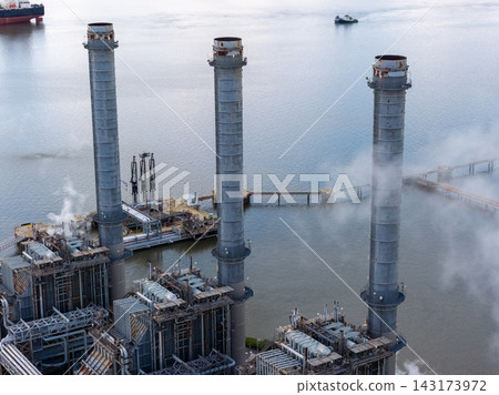 Aerial view of industrial power station stacks emitting white smoke Aerial view of industrial power station stacks emitting white smoke 143173972