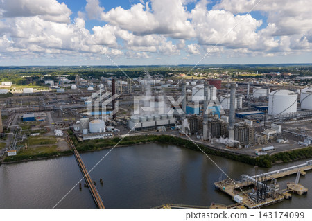 Aerial view of large industrial power plant complex by a river Aerial view of large industrial power plant complex by a river 143174099