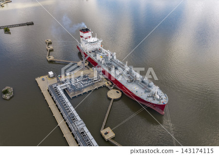 Aerial view of a large chemical tanker ship docked at energy terminal Aerial view of a large chemical tanker ship docked at energy terminal 143174115