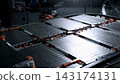 EV car service. Electric vehicle battery pack being serviced or inspected in automotive workshop. Large battery modules and high voltage components. Modern EV power systems. Lithium ion NMC NCA or LFP 143174131