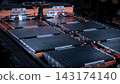 EV car service. Electric vehicle battery pack being serviced or inspected in automotive workshop. Large battery modules and high voltage components. Modern EV power systems. Lithium ion NMC NCA or LFP 143174140