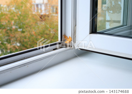 Open Plastic Window with Autumn Leaf on Frame for Home Cleaning Concept. Domestic Hygiene Maintenance Open Plastic Window with Autumn Leaf on Frame for Home Cleaning Concept. Domestic Hygiene Maintenance 143174688