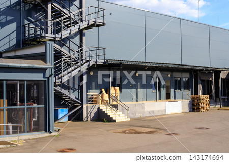 Loading Area behind Supermarket Building with Metal Emergency Stairs for Logistics Concept 143174694