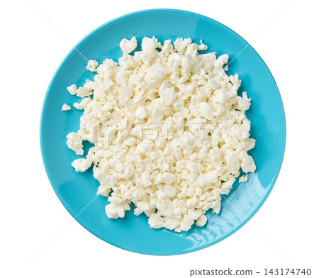 Fresh cottage cheese in a blue plate isolated on a white background, top view. Fresh cottage cheese in a blue plate isolated on a white background, top view. 143174740