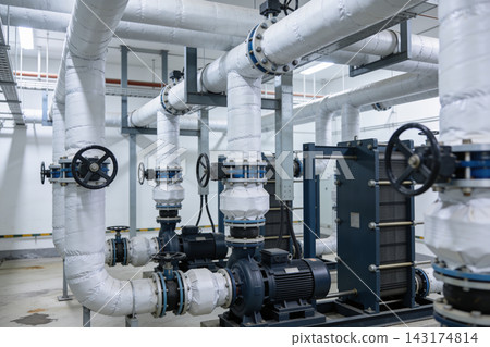 Industrial pump system with insulated piping and heat exchanger in a modern mechanical room Industrial pump system with insulated piping and heat exchanger in a modern mechanical room 143174814