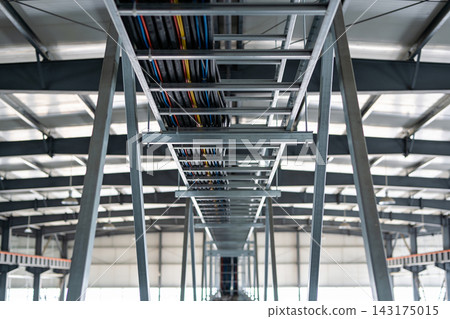 Industrial cable tray system installed on the ceiling of a large modern warehouse facility Industrial cable tray system installed on the ceiling of a large modern warehouse facility 143175015