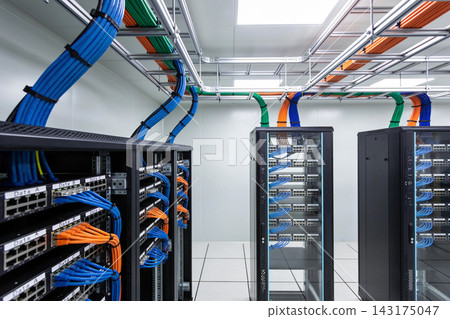 Modern server room with organized network cables and black racks in a clean data center facility Modern server room with organized network cables and black racks in a clean data center facility 143175047
