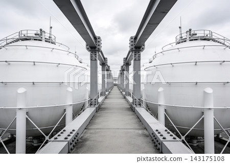 Symmetrical view of large white spherical gas storage tanks at an industrial chemical facility Symmetrical view of large white spherical gas storage tanks at an industrial chemical facility 143175108