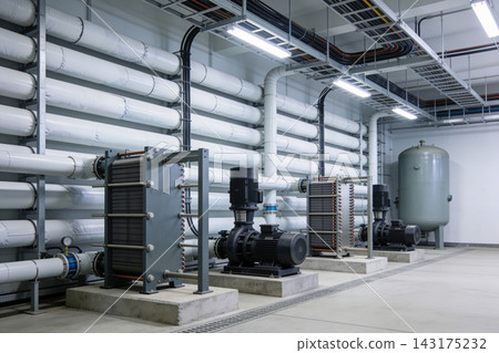 Industrial mechanical room featuring plate heat exchangers and pumps with insulated piping system Industrial mechanical room featuring plate heat exchangers and pumps with insulated piping system 143175232