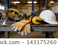 Essential industrial safety equipment displayed on a metal workbench in a professional workshop 143175260
