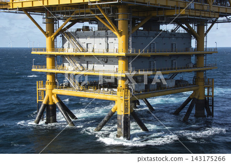 Offshore oil and gas platform structure standing in the middle of the deep blue ocean waters Offshore oil and gas platform structure standing in the middle of the deep blue ocean waters 143175266