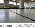Industrial warehouse floor with a long structural crack running through the gray concrete surface 143175271
