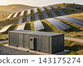 Large battery energy storage system container at a hillside solar farm during golden hour 143175274
