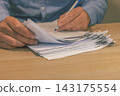 Office worker signing corporate paper documents on desk 143175554