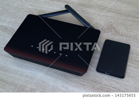 Wireless router and external storage device on wooden office desk, cloud networking. Wireless router and external storage device on wooden office desk, cloud networking. 143175655