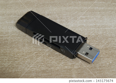 Perspective view of USB card reader on wooden desk Perspective view of USB card reader on wooden desk 143175674