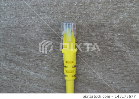 Close-up of yellow RJ45 Ethernet network connector plug Close-up of yellow RJ45 Ethernet network connector plug 143175677